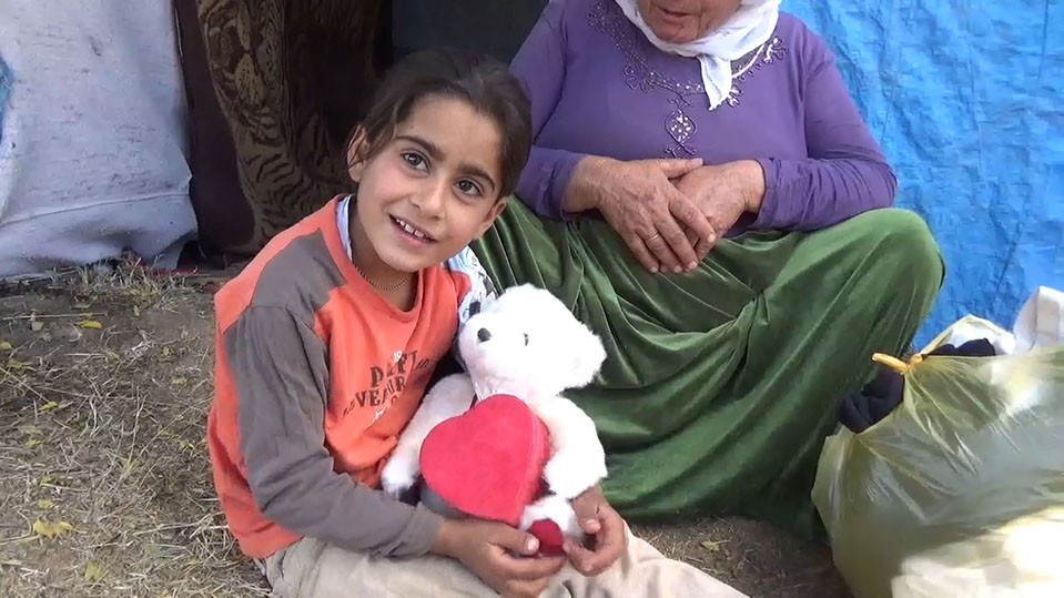 Child receiving toys, Iraq relief trip